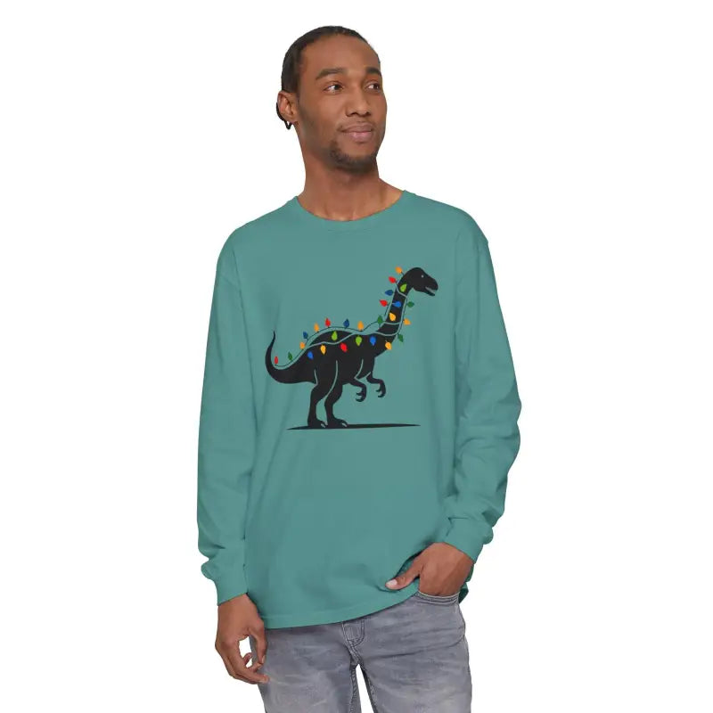 Teal long-sleeved Christmas shirt featuring a dinosaur adorned with lights