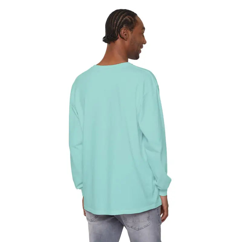 Man wearing a teal long-sleeved shirt featuring Christmas Dinosaur and lights design