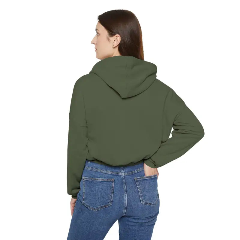 Woman in olive green Coexist cinched bottom hoodie and blue jeans