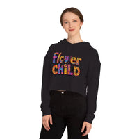 Woman wearing black cropped hoodie with colorful Flower Child graphic in pastel floral print