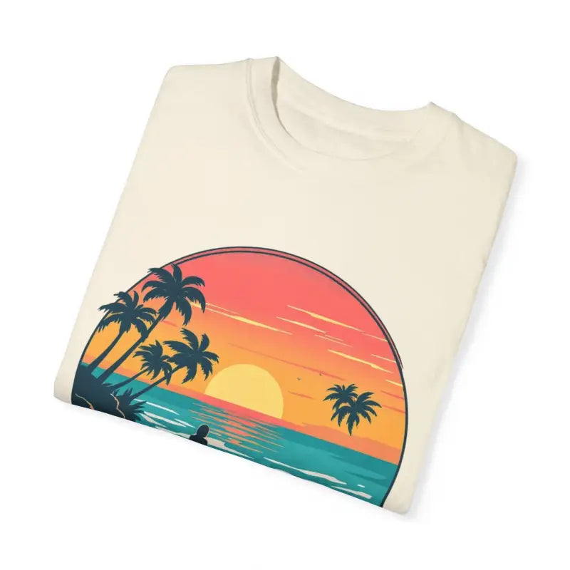 Folded t-shirt featuring a tropical sunset design, Suns Out Buns Out Summer Tee