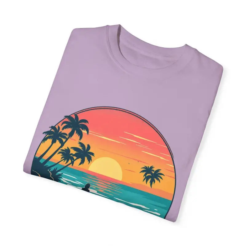Folded lavender t-shirt featuring sunset beach graphic from Suns Out Buns Out collection