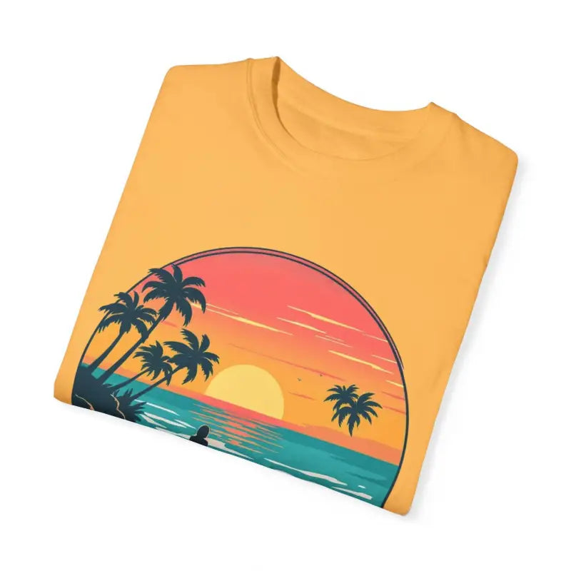Folded yellow Suns Out Buns Out t-shirt featuring a beach sunset graphic