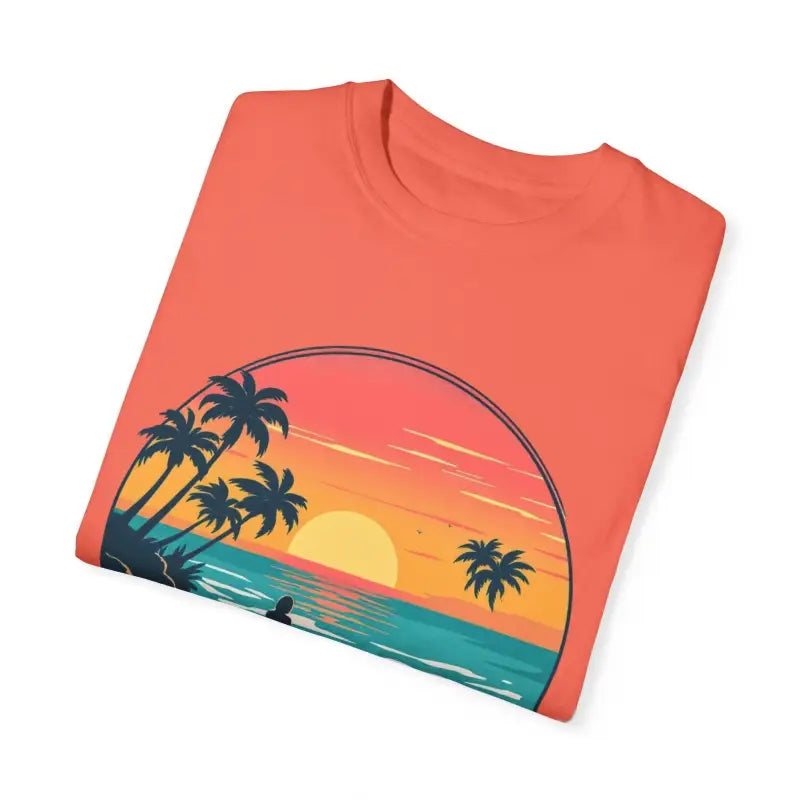 Folded coral t-shirt featuring beach sunset graphic from Suns Out Buns Out collection