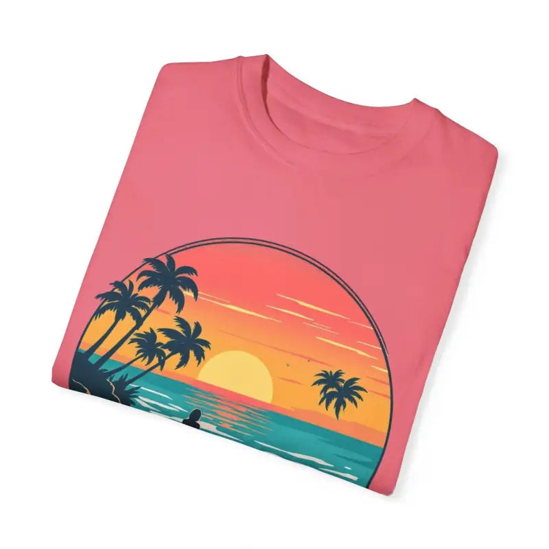 Folded pink T-shirt featuring beach sunset graphic from Suns Out Buns Out collection