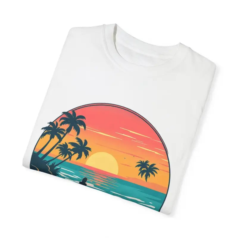 Folded white t-shirt featuring sunset beach graphic from Suns Out Buns Out collection