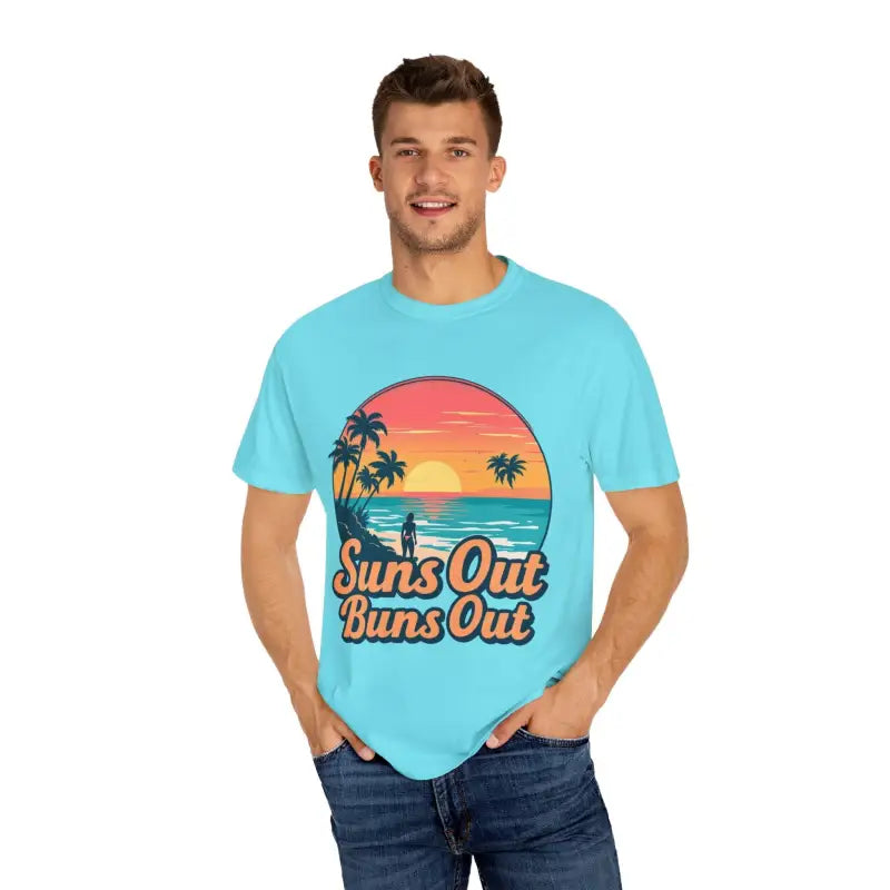 Man showcasing Suns Out Buns Out Unisex Garment Dyed Summer T Shirt in casual setting