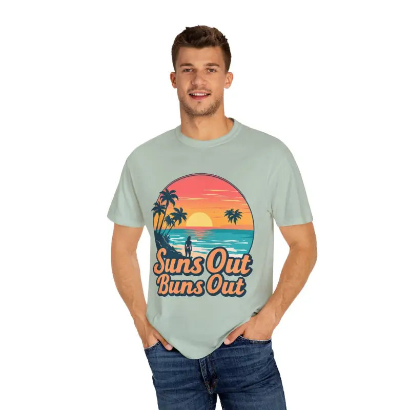 Man showcasing Suns Out Buns Out Unisex Garment Dyed Summer T Shirt in a casual setting