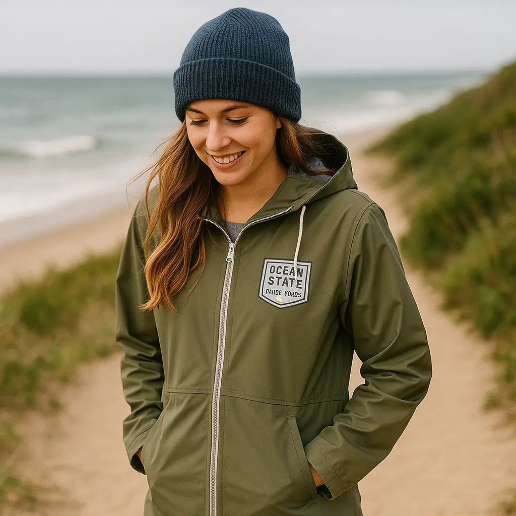 girl wearing navy beanie walking along beach dunes