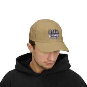Man wearing tan baseball cap with GOD Grampy on Duty and black hoodie