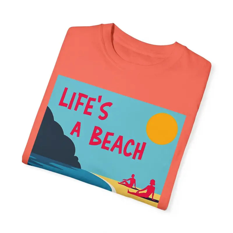 Folded coral Beach Life Unisex T Shirt featuring a vibrant beach graphic