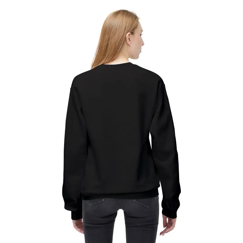 Rear view of a woman wearing a black long-sleeved crewneck sweatshirt and dark pants