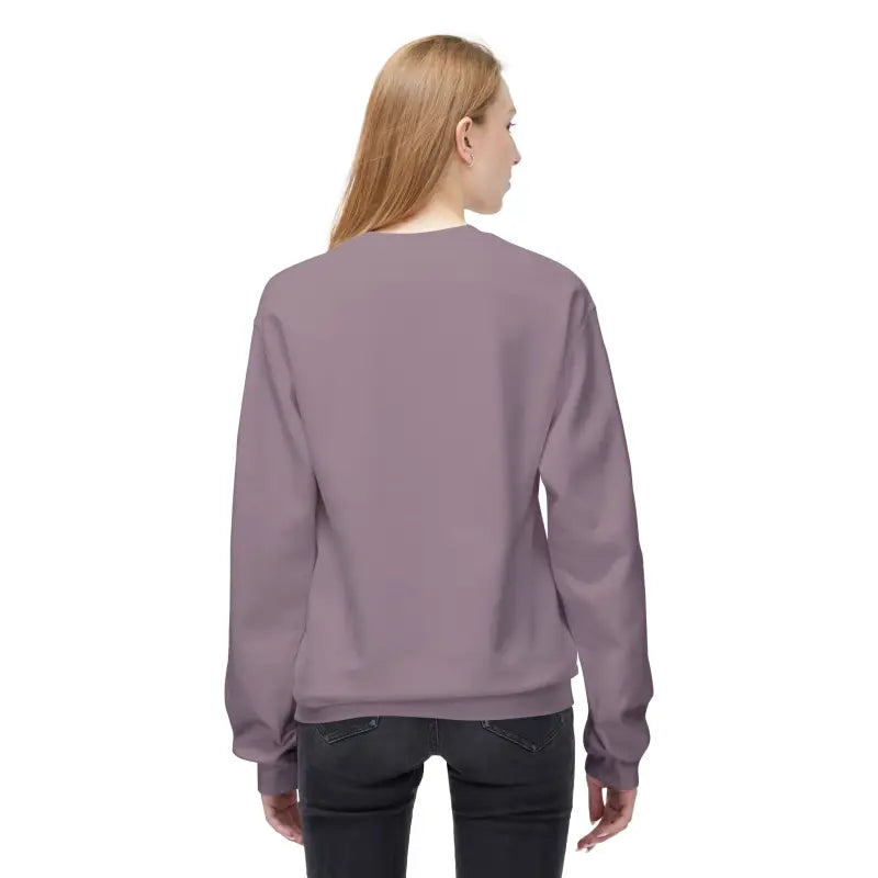 Woman wearing a purple crewneck sweatshirt and dark jeans, part of Block Island collection