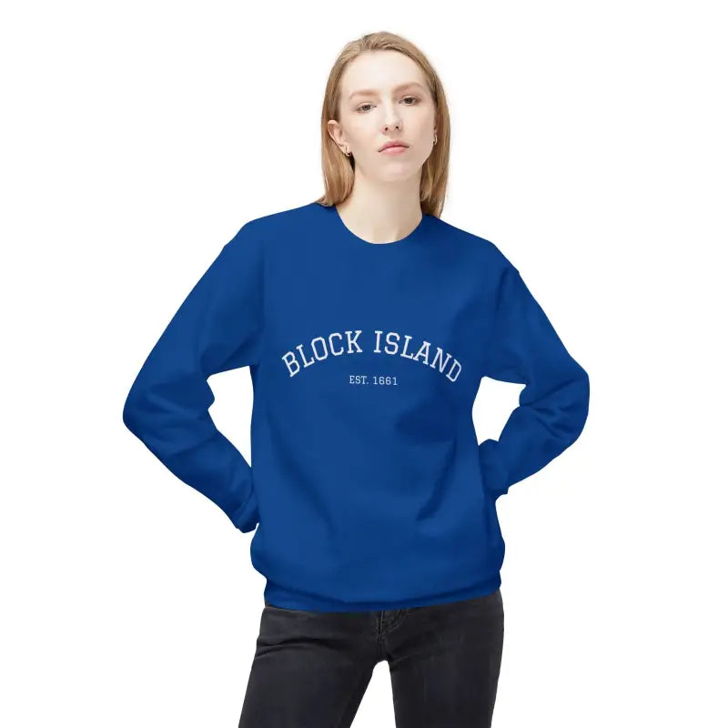 Woman wearing a royal blue Block Island Crewneck Sweatshirt and dark jeans