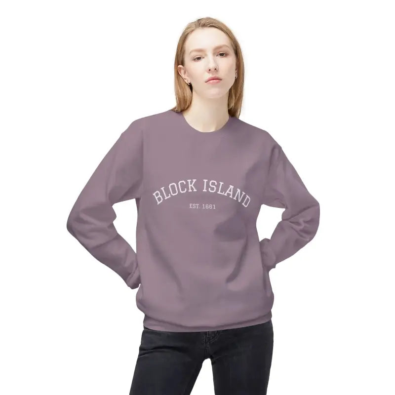Woman wearing a purple Block Island crewneck sweatshirt with EST 1661 logo on chest