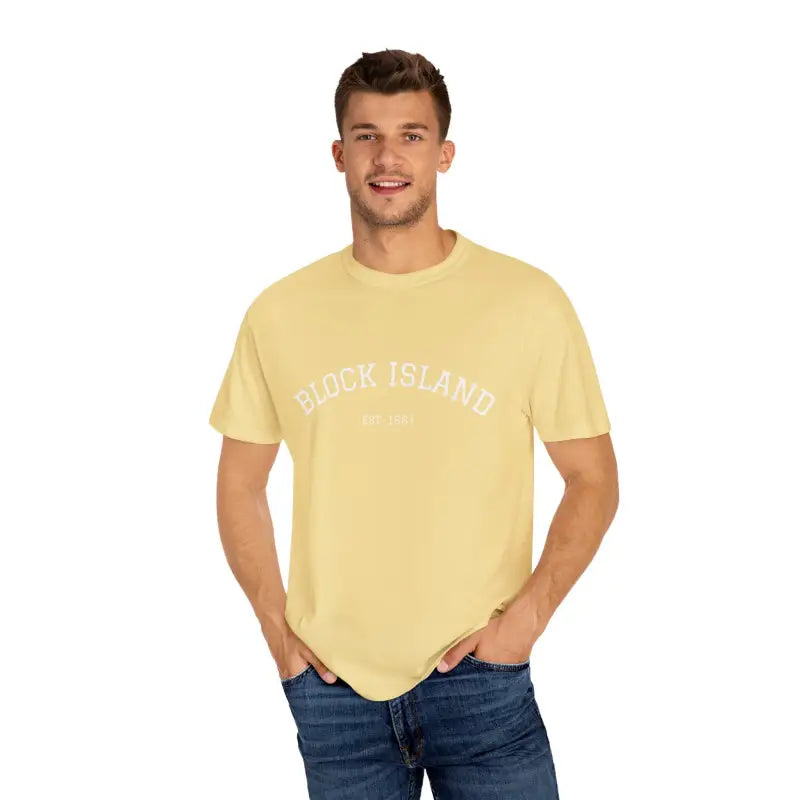 Smiling man wearing a yellow t-shirt and blue jeans in front of Block Island Est 1661 T-shirt display