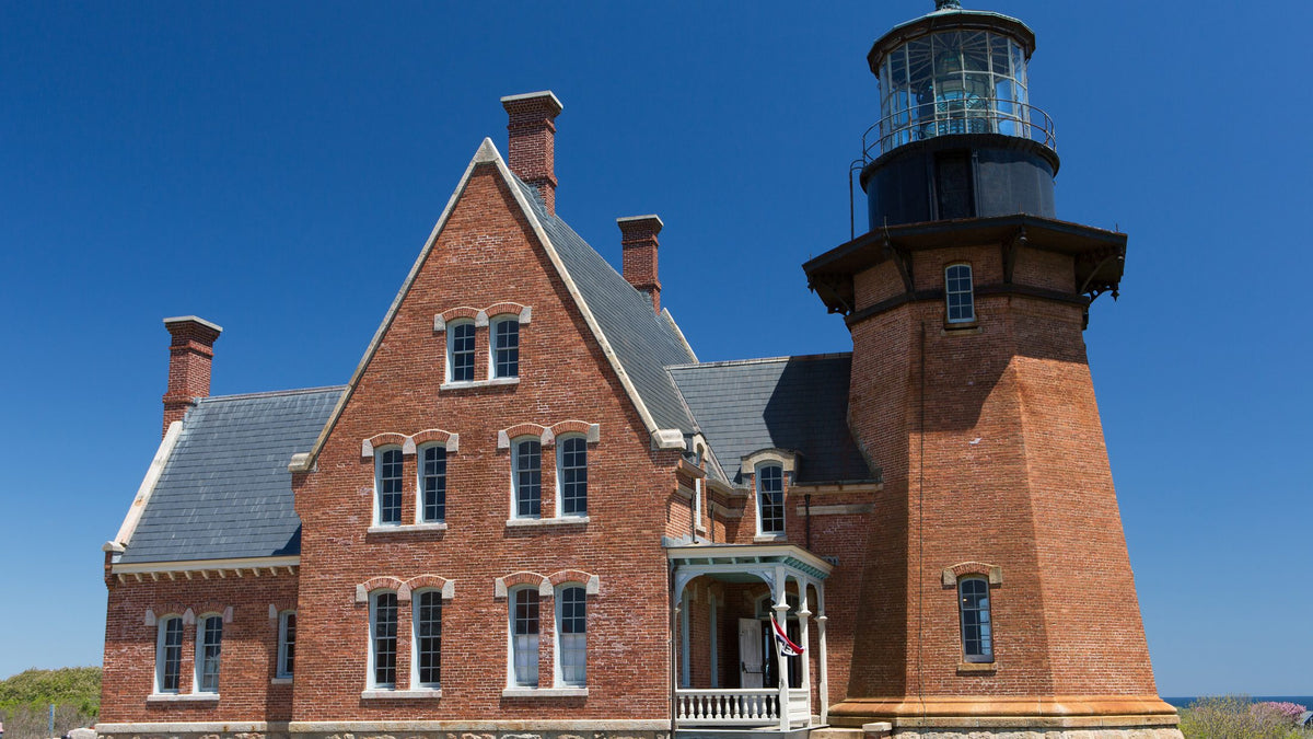 Block Island Southeast Lighthouse beneath a clear blue sky.