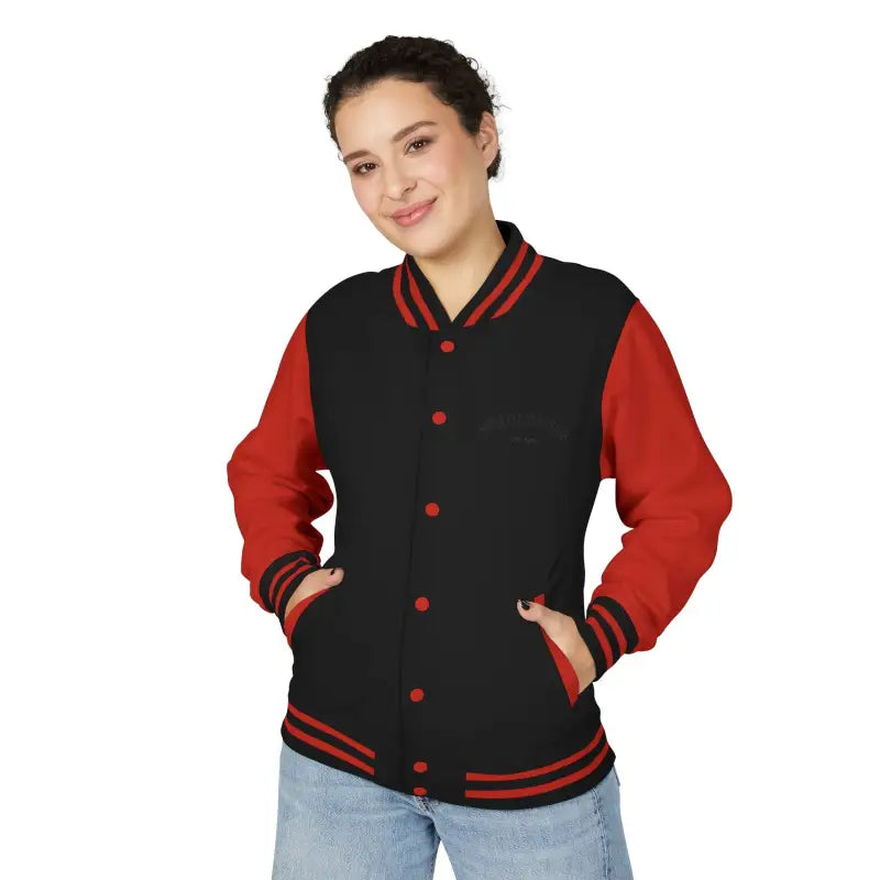 Black varsity jacket with red sleeves, collar, cuffs, hem, snap buttons, and pockets