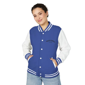 Woman wearing a blue and white varsity jacket and light-wash jeans from Classic Varsity Jacket Collection