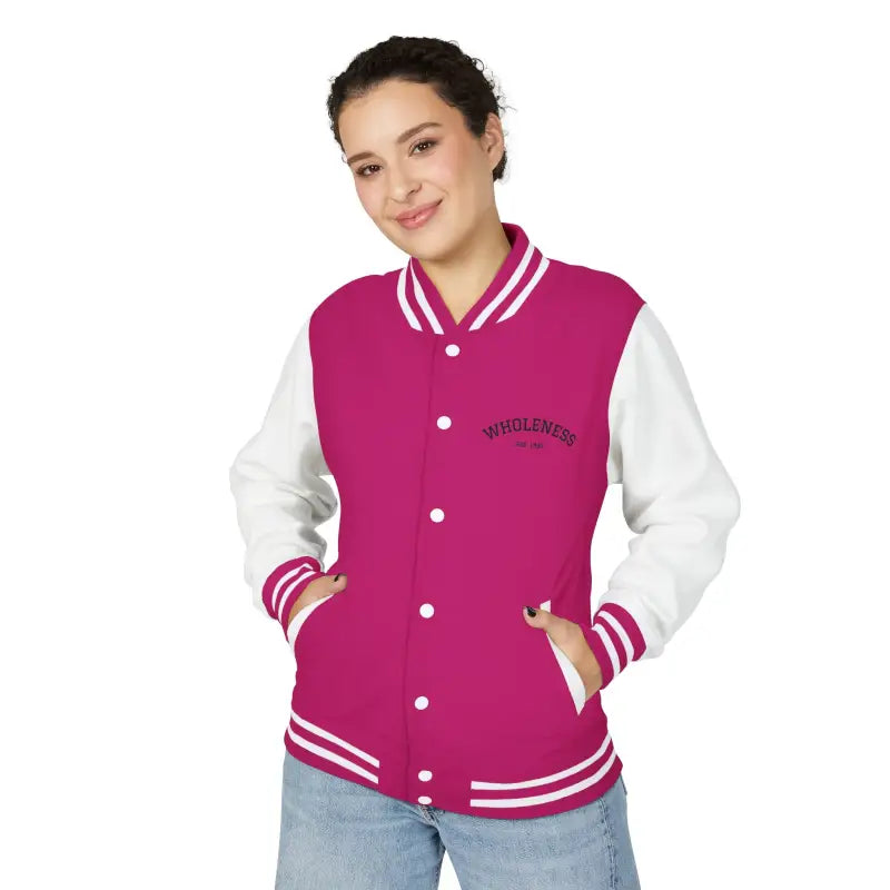 Woman wearing a magenta and white varsity jacket with blue jeans from the Classic Varsity Jacket Collection