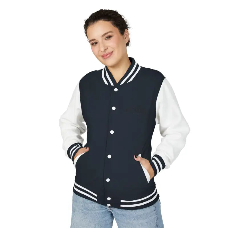 Woman wearing navy blue and white varsity jacket with light-wash jeans from Classic Varsity Jacket Collection