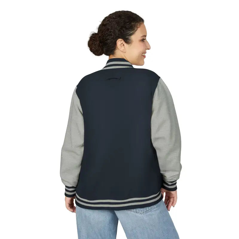 Woman wearing navy and grey varsity jacket with light-wash jeans from Classic Varsity Jacket Collection
