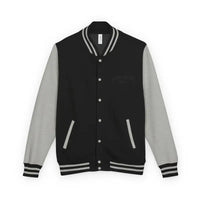 Black varsity jacket with light grey sleeves and white striped collar cuffs and waist