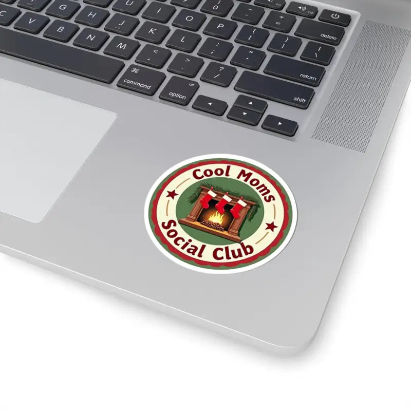 Round sticker featuring a cozy fireplace and stockings for Cool Moms Social Club