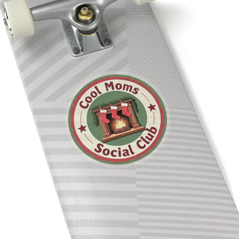 Circular Cool Moms Social Club sticker featuring a cozy fireplace and stockings