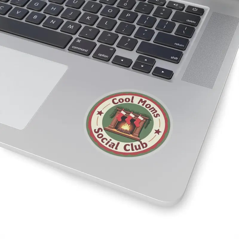 Round Cool Moms Social Club sticker featured in holiday product with fireplace and stockings