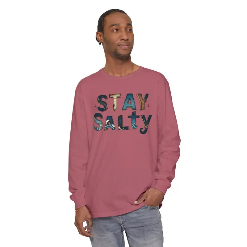 Adult male wearing a Cream Coral Pink Stay Salty graphic long sleeve T shirt