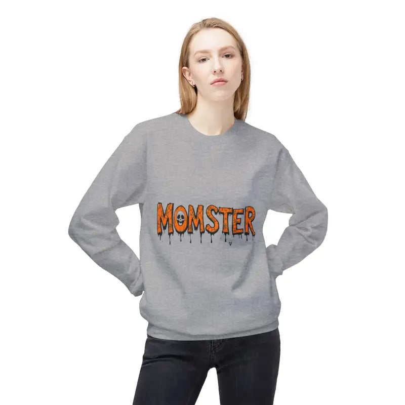 Woman wearing gray crewneck sweatshirt with MOMSTER dripping orange text and skull detail