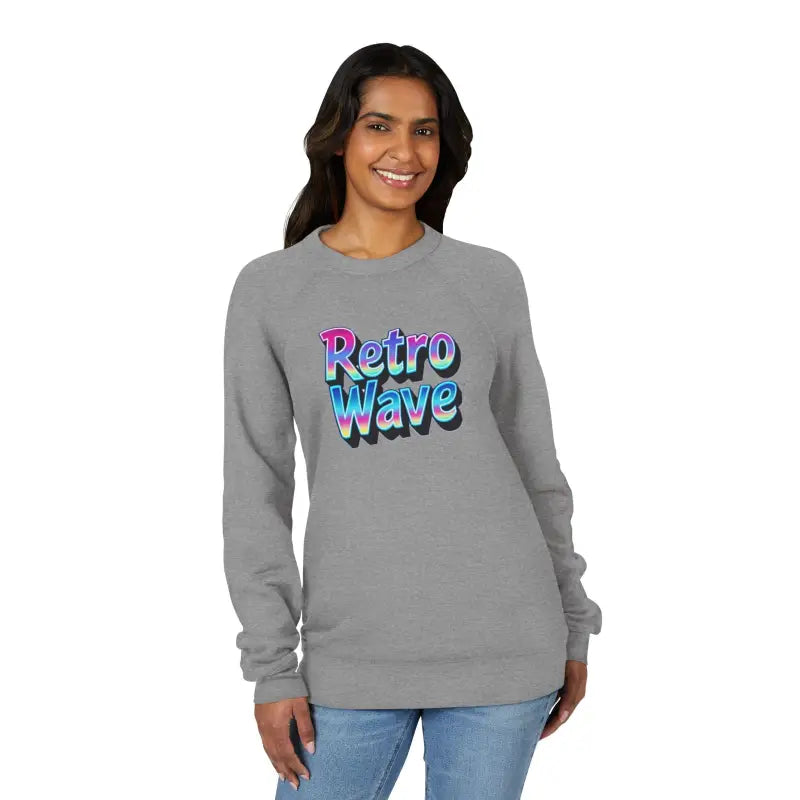 Woman wearing a dark gray Retro Wave graphic sweatshirt and blue jeans