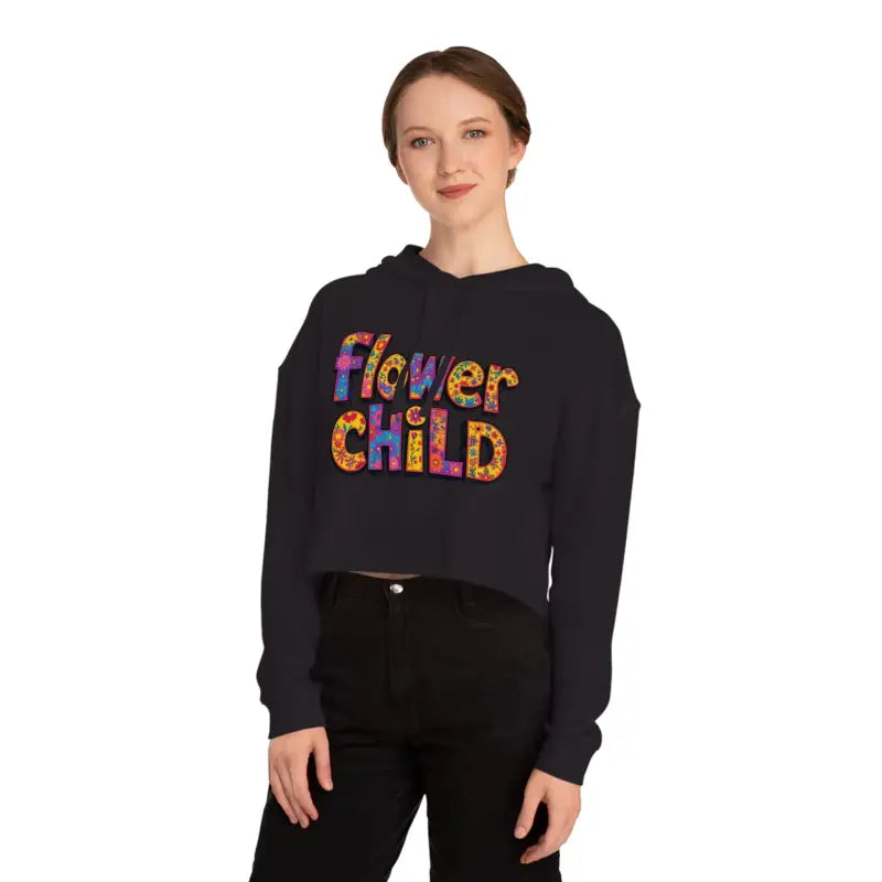 Woman wearing black cropped hoodie with colorful Flower Child graphic in pastel floral print