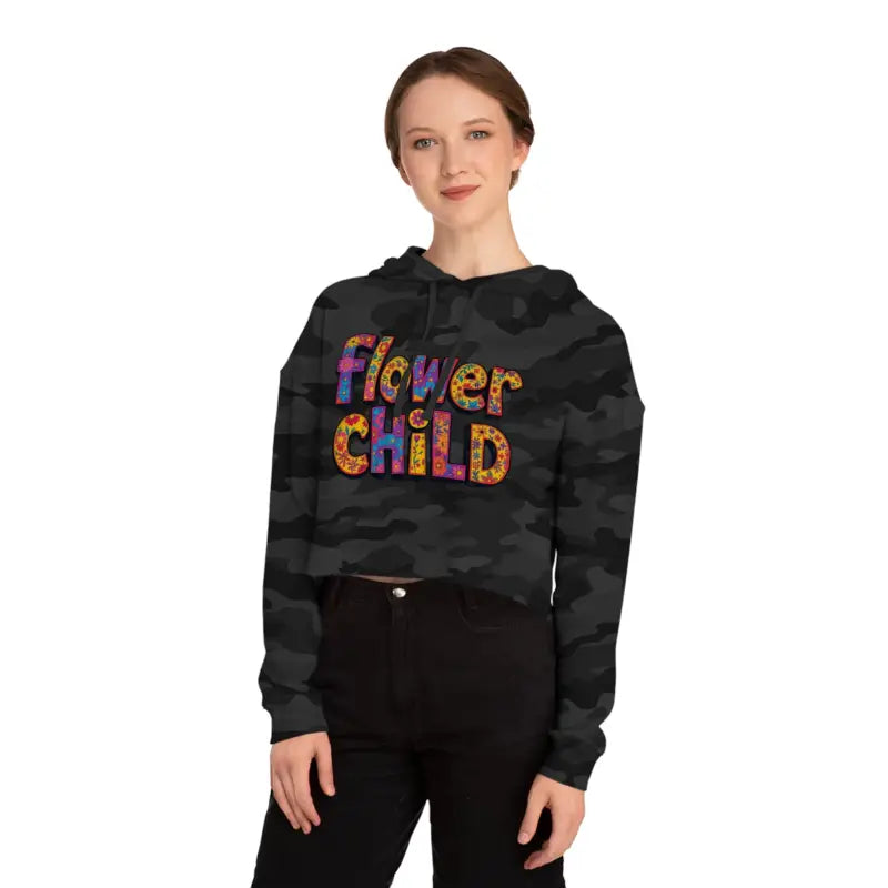 Woman wearing Flower Child Cropped Hoodie in Pastel Floral Print with black camouflage crop hoodie and black pants