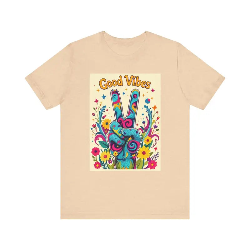 Beige t-shirt featuring a colorful peace sign graphic for Good Vibes Unisex Jersey Tee
