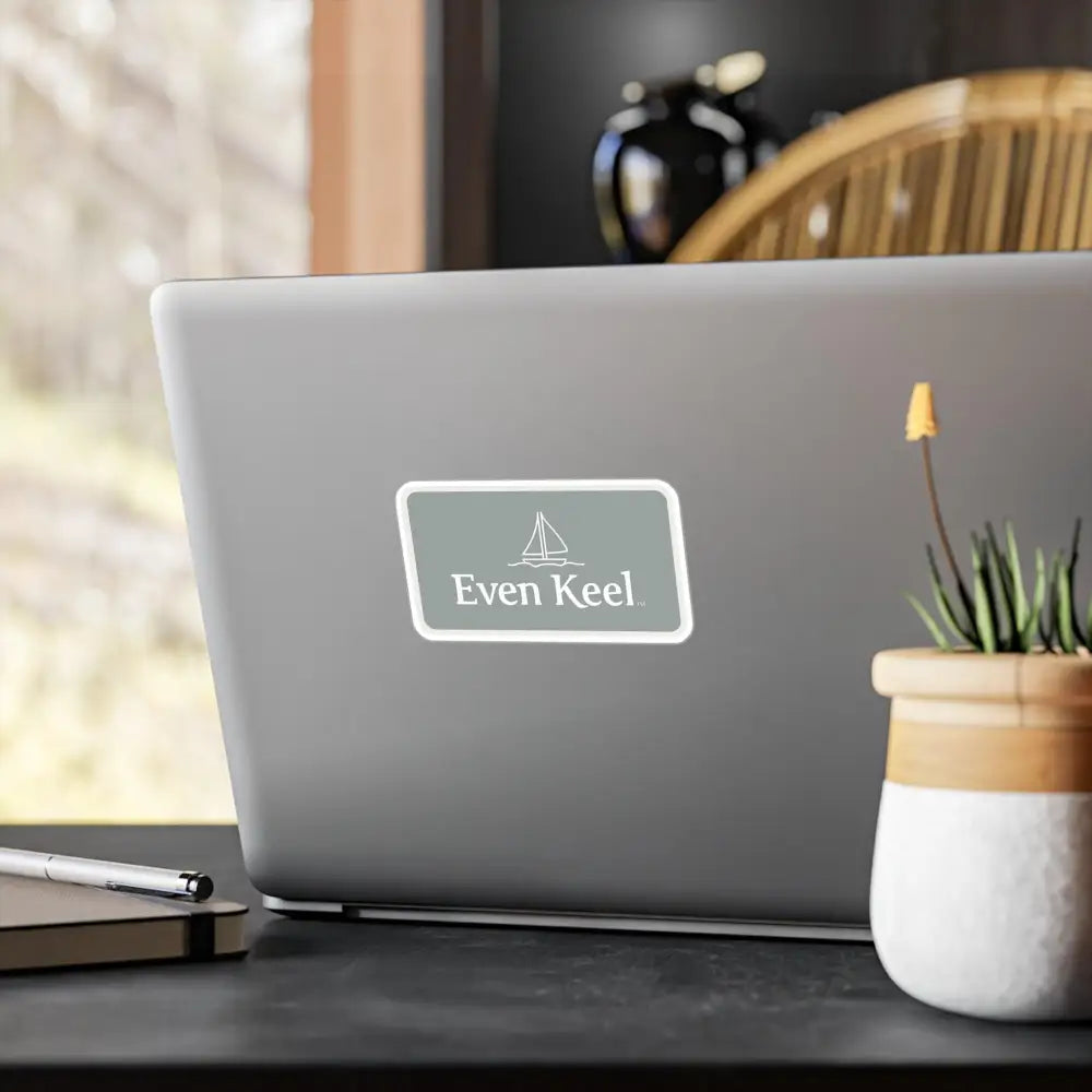 Gray Even Keel Sailboat Sign on a laptop adorned with an Even Keel sticker