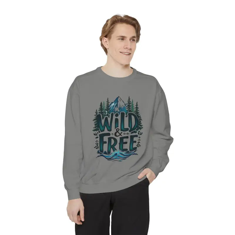 Gray crewneck sweatshirt with mountain, tree, water graphic and WILD & FREE text