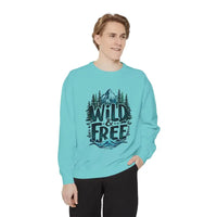 Light blue crewneck sweatshirt with mountain, tree, and wave graphic and WILD & FREE text