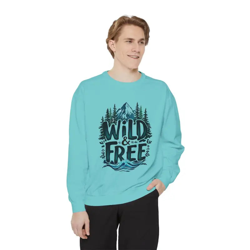 Light blue crewneck sweatshirt with mountain, tree, and wave graphic and WILD & FREE text