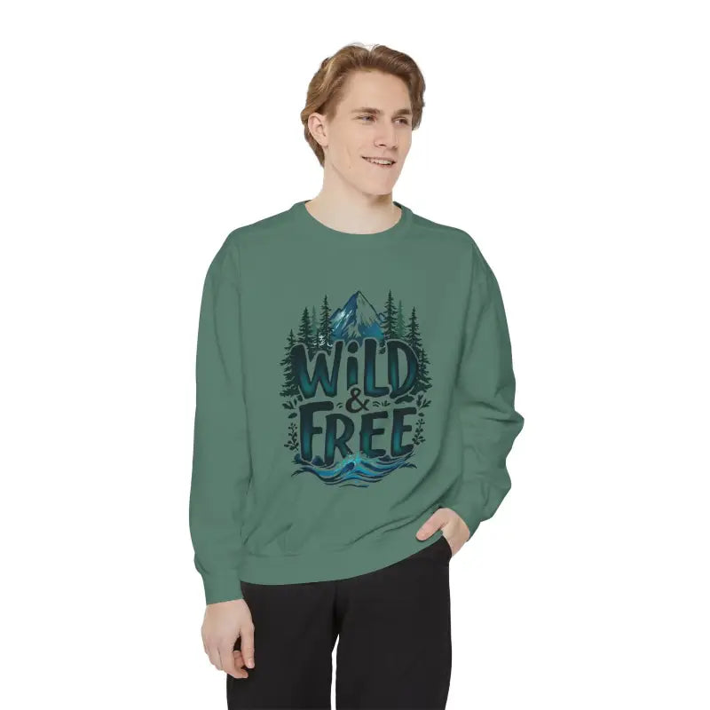 Man wearing light blue gray and white crew neck sweatshirt with Wild and Free graphic design