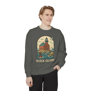 Man wearing a dark gray long sleeve crewneck sweatshirt with a lighthouse and seagulls graphic