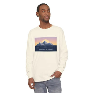 Man wearing off-white long sleeve T shirt with mountain sunset and ocean graphic