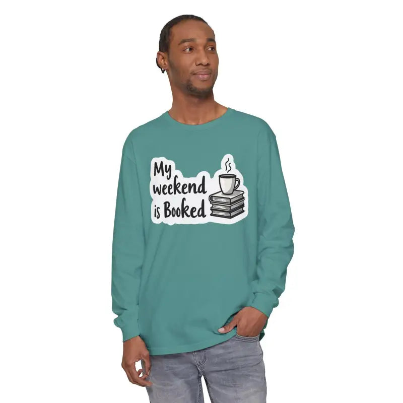 Long-sleeved teal shirt featuring ’My Weekend is Booked’ design for unisex wear