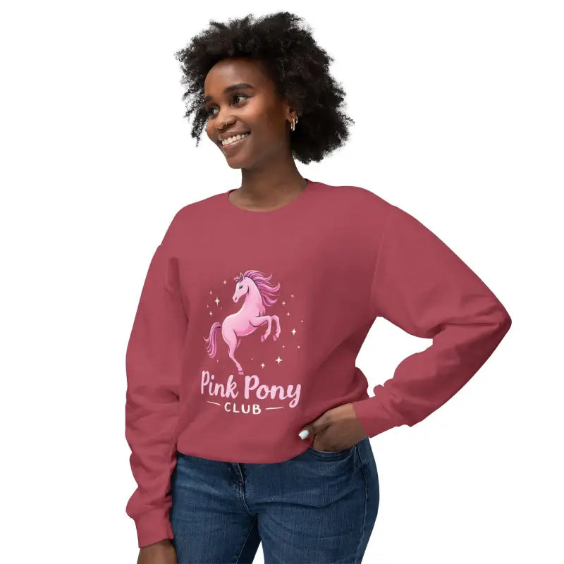 Woman wearing Pink Pony Graphic Crewneck Sweatshirt with maroon color and blue jeans