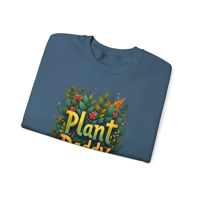 Folded blue t-shirt displayed with Plant Daddy Jungle Sweatshirt for casual styling