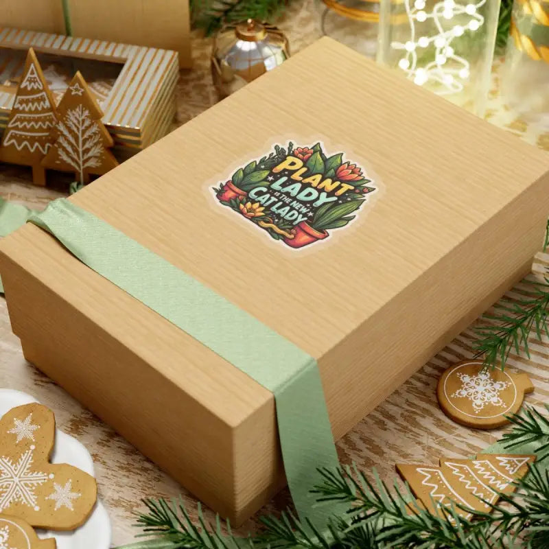 Tan gift box with green ribbon showcasing Plant Lady Is The New Cat Lady Sticker