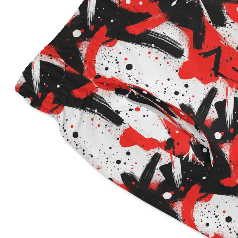 Red and black abstract patterned swim trunks displayed in the Stylish Splash Swim Trunks product image
