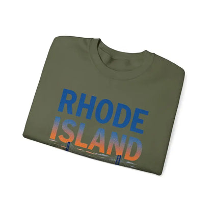 Folded Rhode Island t-shirt next to Rhode Island Sunset Crewneck Sweatshirt in Black, White, and Pink