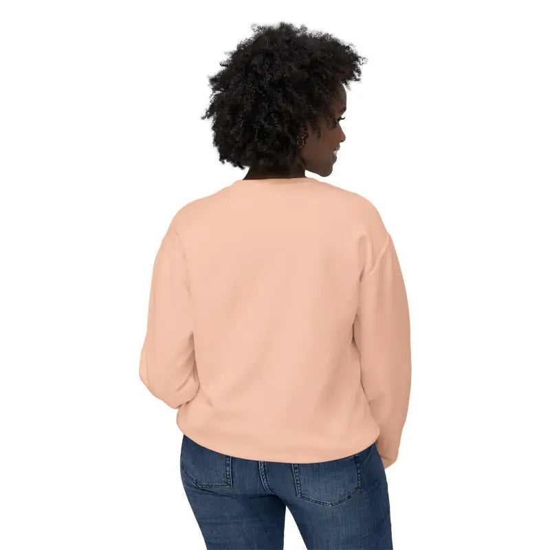 Peach-colored Rhody Unisex Lightweight Crewneck Sweatshirt paired with blue jeans
